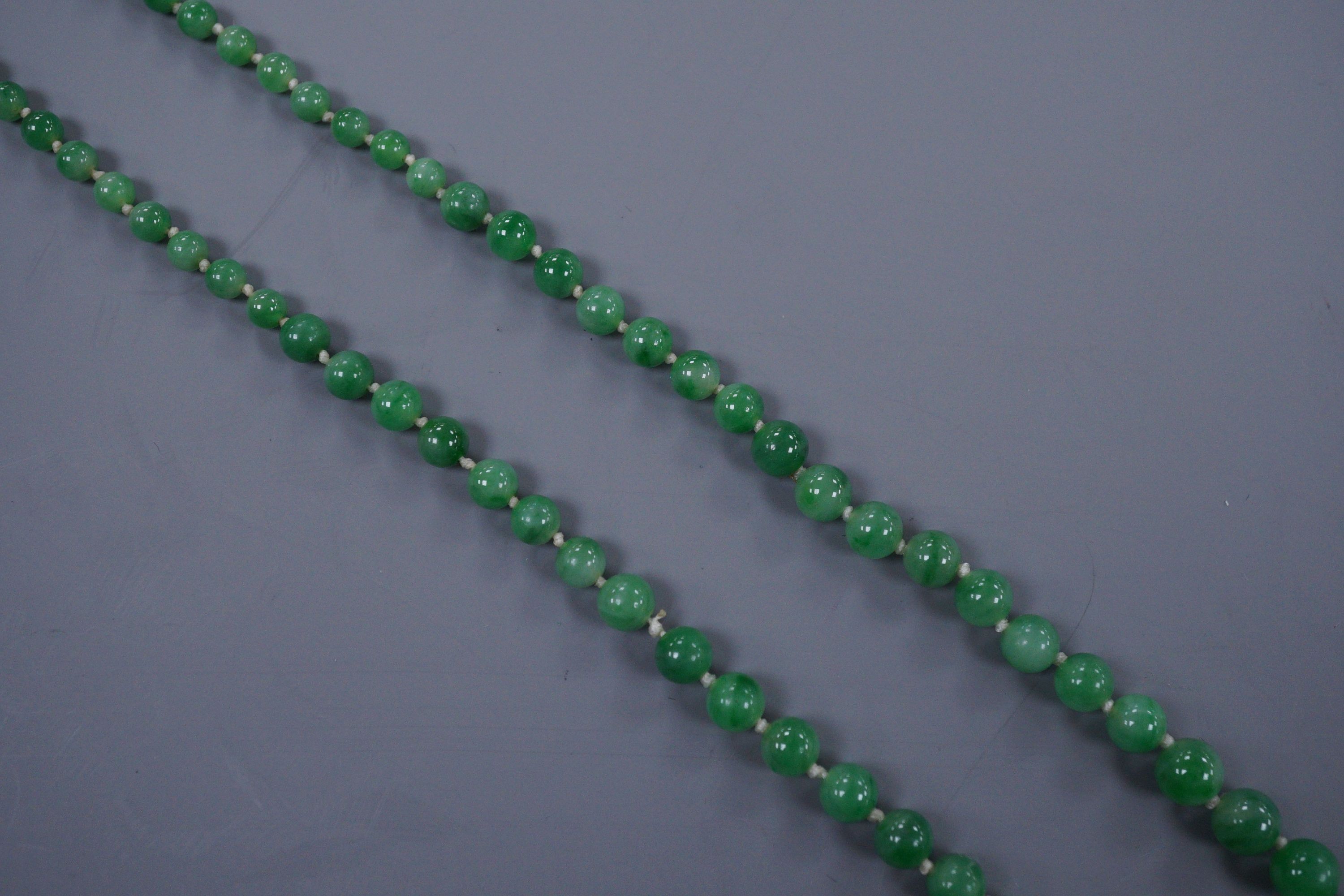 A graduated jade bead necklace with diamond set clasp stamped 9ct, 50cm